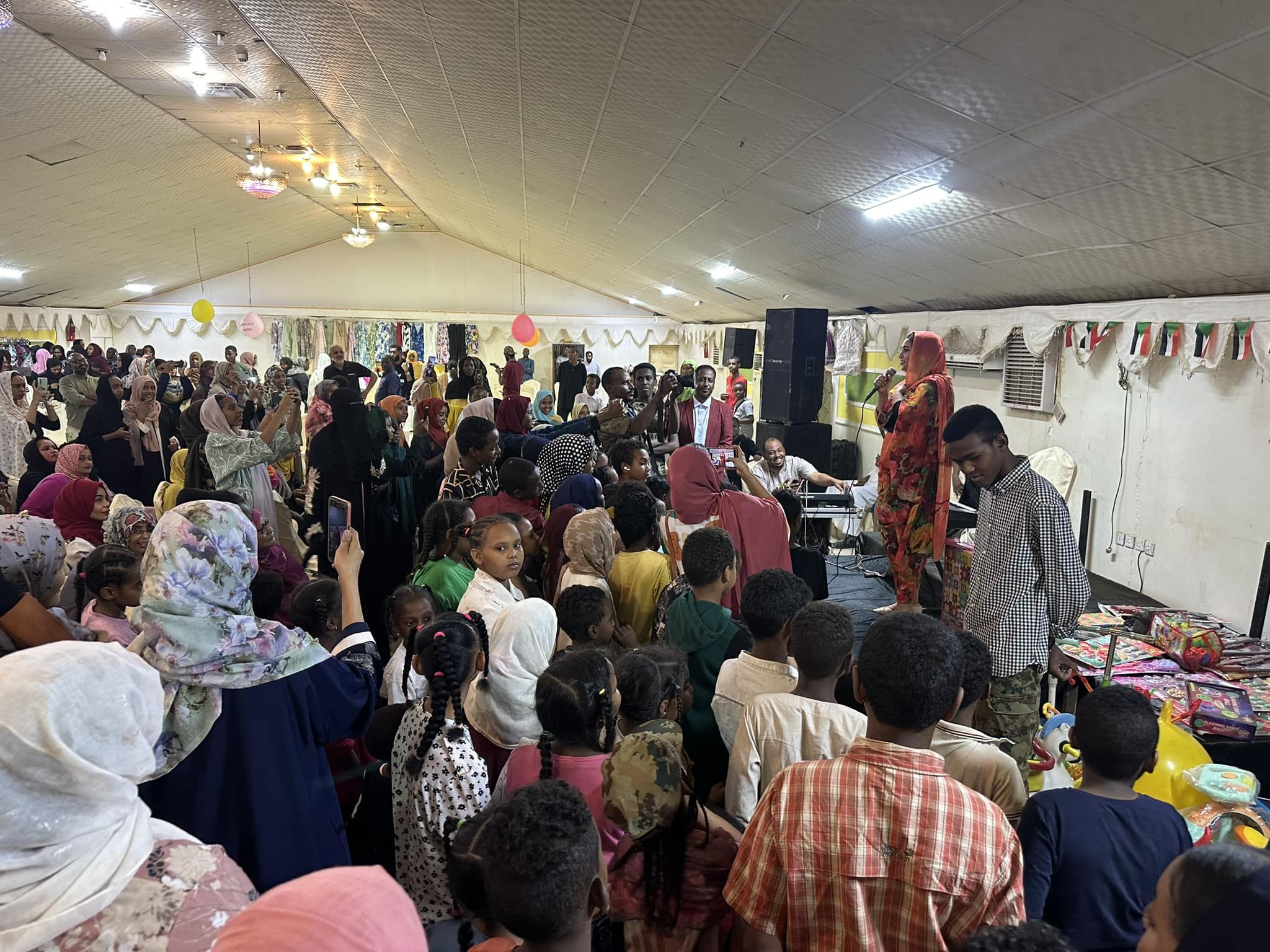 شاهد بالصورة والفيديو.. الفرحة تعود لأمدر.. إقامة أضخم “بازار” بإحدى صالات الأفراح بأم درمان بحضور الآلاف من المواطنين ومطرب الحفل يشعل القاعة بالأغاني الحماسية