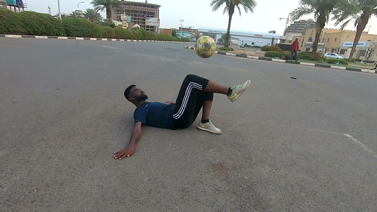 شاهد بالفيديو.. لاعب سوداني يستعرض مهاراته العالية في كرة القدم أمام إحدى إشارات المرور بالقاهرة ويجذب أنظار المارة وأصحاب السيارات