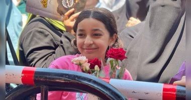 طفلة تنتظر شقيقتها بالورود أمام لجان الثانوية العامة فى الجيزة