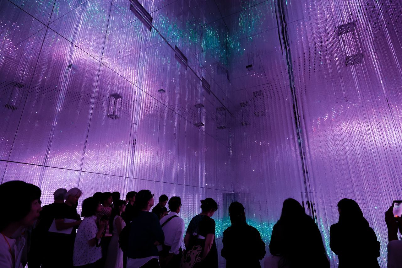 ”عالم البلورات اللانهائي“ (Infinite Crystal World): تولّد الأسطح العاكسة ونقاط الضوء التي لا تُحصى أشكالًا مجسمة فريدة. (© Nippon.com)