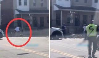 تراند اليوم : شاهد : كيف تعامل شرطي أمريكي مع 4 كلاب حاولت تفترس رجل وسط شارع عام