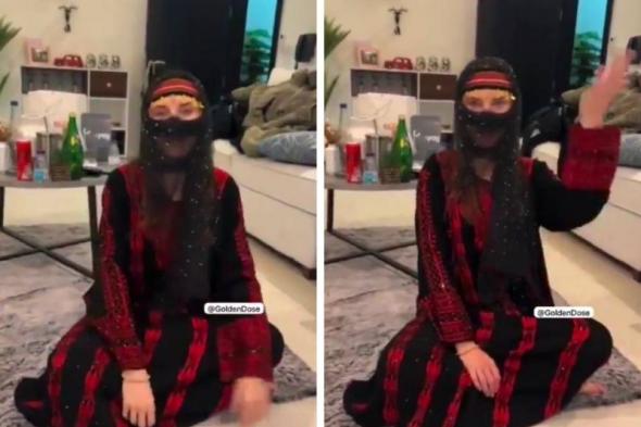 شاهد .. موطن سعودي يشارك فيديو لزوجته البريطانية وهي ترتدي البرقع والزي التراثي السعودي